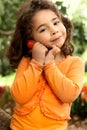 Beautiful little girl holding a flower picked from the garden Royalty Free Stock Photo