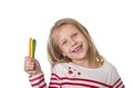 Beautiful little girl holding multicolor crayons set in art school children education concept Royalty Free Stock Photo