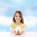 Beautiful little girl holding paper house cutout Royalty Free Stock Photo