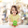 Beautiful little girl holding paper house cutout Royalty Free Stock Photo