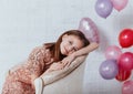 Beautiful little girl joking at birthday party. young ladi with balloons preparing for festive