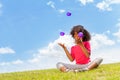 Beautiful little girl juggle with balls on lawn