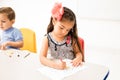 Kindergarten student coloring in class Royalty Free Stock Photo