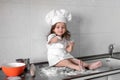 Beautiful little girl learns to cook a meal in the kitchen Royalty Free Stock Photo