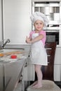 Beautiful little girl learns to cook a meal in the kitchen Royalty Free Stock Photo