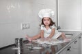 Beautiful little girl learns to cook a meal in the kitchen Royalty Free Stock Photo