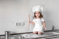 Beautiful little girl learns to cook a meal in the kitchen Royalty Free Stock Photo