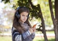 Beautiful little girl listening to music on headphones Royalty Free Stock Photo