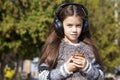 Beautiful little girl listening to music on headphones Royalty Free Stock Photo