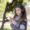 Beautiful little girl listening to music on headphones Royalty Free Stock Photo