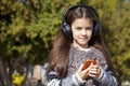 Beautiful little girl listening to music on headphones Royalty Free Stock Photo