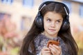 Beautiful little girl listening to music on headphones Royalty Free Stock Photo