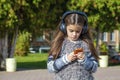 Beautiful little girl listening to music on headphones Royalty Free Stock Photo