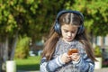 Beautiful little girl listening to music on headphones Royalty Free Stock Photo