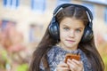 Beautiful little girl listening to music on headphones Royalty Free Stock Photo