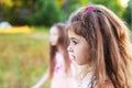 Beautiful little girl with long curly hair, looking worried at s Royalty Free Stock Photo