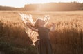 Beautiful little girl with long hair walking through a wheat field on a sunny day. Outdoors portrait. Kids relaxing Royalty Free Stock Photo