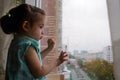 beautiful little girl looking out the window in the rain Royalty Free Stock Photo