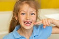 Beautiful little girl lost the first milk tooth. Happy child dropped the first milk tooth. Royalty Free Stock Photo
