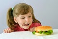 Beautiful little girl loves hamburger fastfood, convenience foods