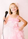 Beautiful little girl with microphone in princess dress Royalty Free Stock Photo