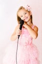 Beautiful little girl with microphone in princess dress Royalty Free Stock Photo