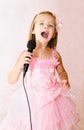 Beautiful little girl with microphone in princess dress Royalty Free Stock Photo