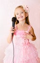 Beautiful little girl with microphone in princess dress Royalty Free Stock Photo