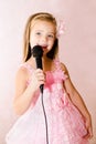 Beautiful little girl with microphone in princess dress Royalty Free Stock Photo