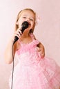 Beautiful little girl with microphone in princess dress Royalty Free Stock Photo