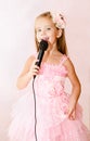 Beautiful little girl with microphone Royalty Free Stock Photo