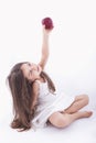 Beautiful little girl offering an apple