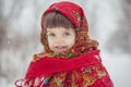 Beautiful little girl in old Russian clothes in a winter forest Royalty Free Stock Photo