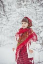 Beautiful little girl in old Russian clothes in a winter forest Royalty Free Stock Photo