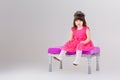 Beautiful little girl in pink Princess dress with crown sitting Royalty Free Stock Photo