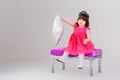 Beautiful little girl in pink Princess dress with crown sitting Royalty Free Stock Photo