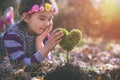 Beautiful little girl planting a heart-shaped tree and dreaming of a beautiful future Royalty Free Stock Photo