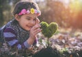 Beautiful little girl planting a heart-shaped tree and dreaming of a beautiful future Royalty Free Stock Photo