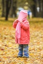 Beautiful little girl playing in the autumn on the nature in the park Royalty Free Stock Photo