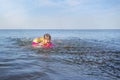 A beautiful little girl playing in the water with splashing sea waves Royalty Free Stock Photo