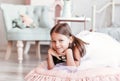 Beautiful little girl plays in the light room. Portrait of a happy child Royalty Free Stock Photo