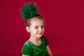 Beautiful little girl princess dancing in luxury green dress isolated on red background. Carnival party with costumes Royalty Free Stock Photo