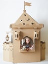 Beautiful little girl in princess dress playing with her toy castle. Royalty Free Stock Photo