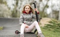 Beautiful little girl rides a scooter in a extreme ride park Royalty Free Stock Photo