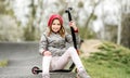 Beautiful little girl rides a scooter in a extreme ride park Royalty Free Stock Photo