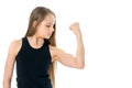 A little girl shows her muscles.