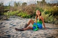 Beautiful little girl sitting on the beach Royalty Free Stock Photo