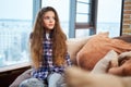 Beautiful little girl sitting on a couch Royalty Free Stock Photo