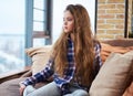 Beautiful little girl sitting on a couch Royalty Free Stock Photo