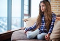 Beautiful little girl sitting on a couch Royalty Free Stock Photo